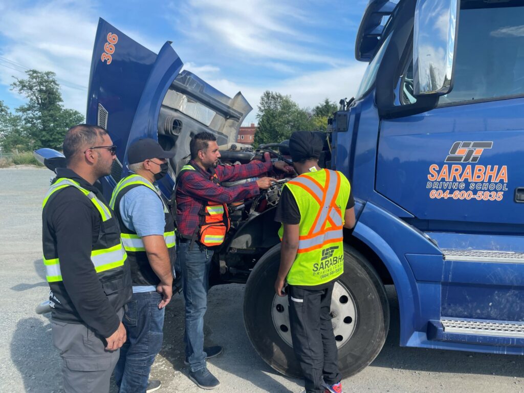 Amrit Grewal shows students how to inspect an engine.