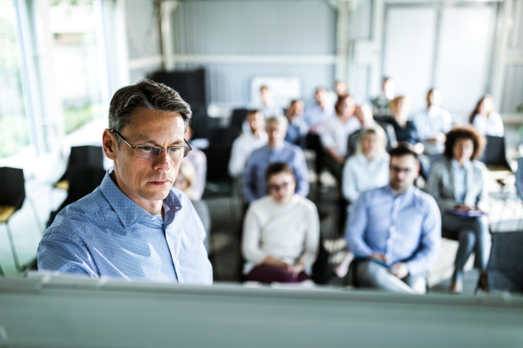 Mid adult entrepreneur having a presentation with his colleagues in a board room.