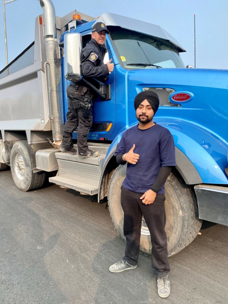 Driver and officer outside the truck